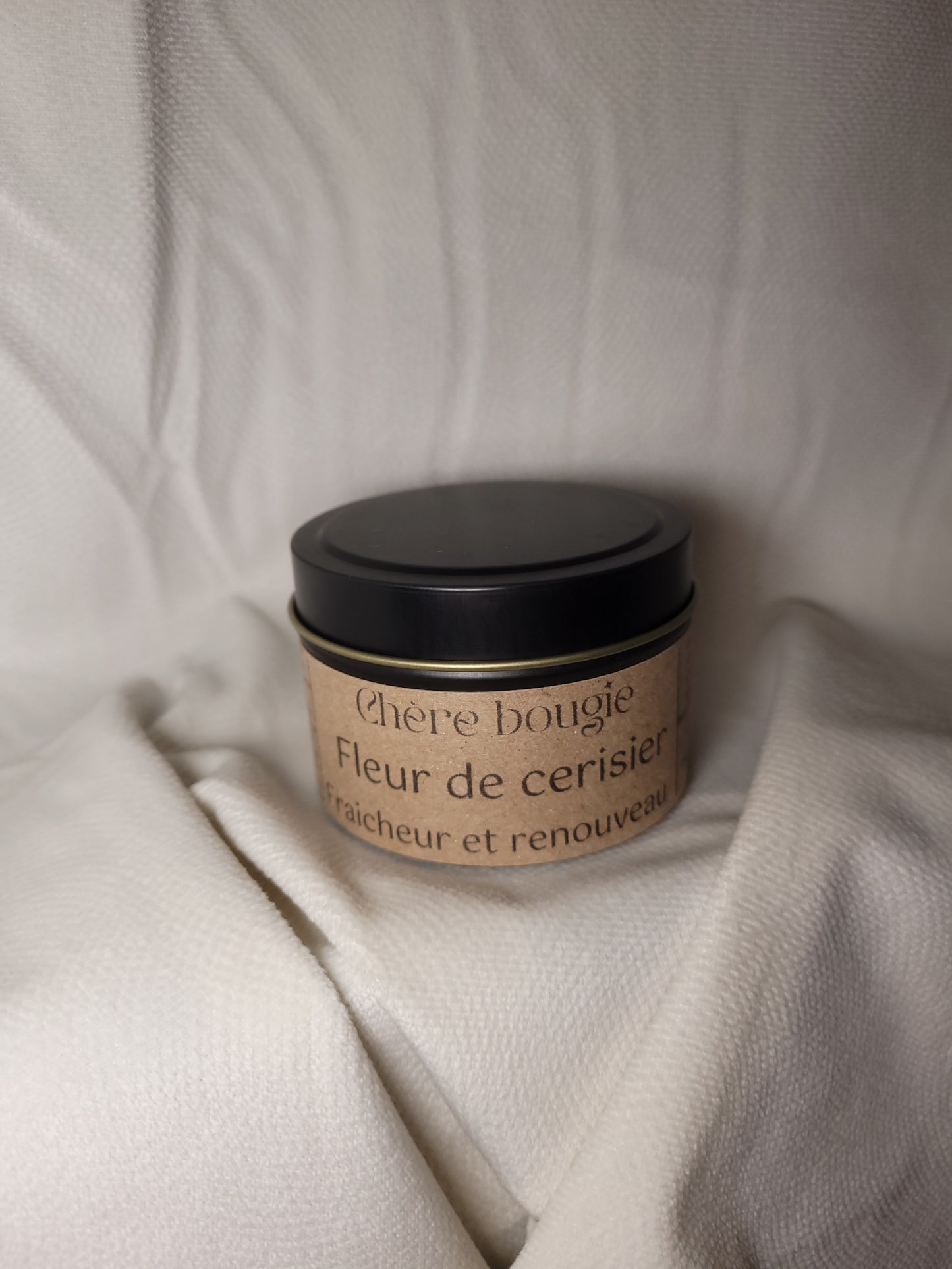 Bougie artisanale fleur de cerisier dans un décor printanier, créant une ambiance apaisante et esthétique dans un intérieur moderne.