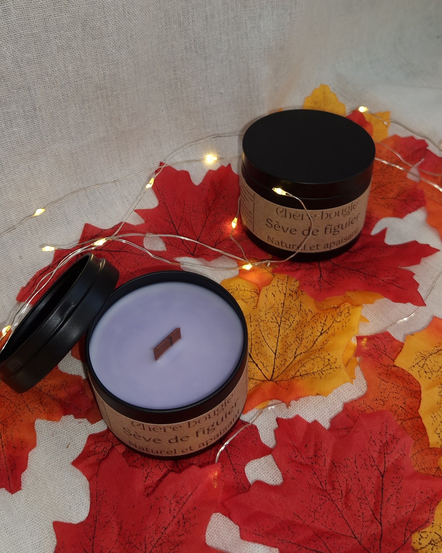 Bougie Sève de Figuier allumée, avec mèche en bois crépitante, diffusant un parfum frais et végétal